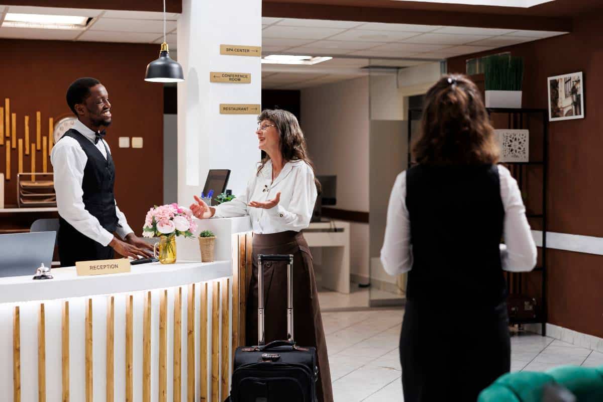 Hotel receptionist providing efficient check-in for a guest.