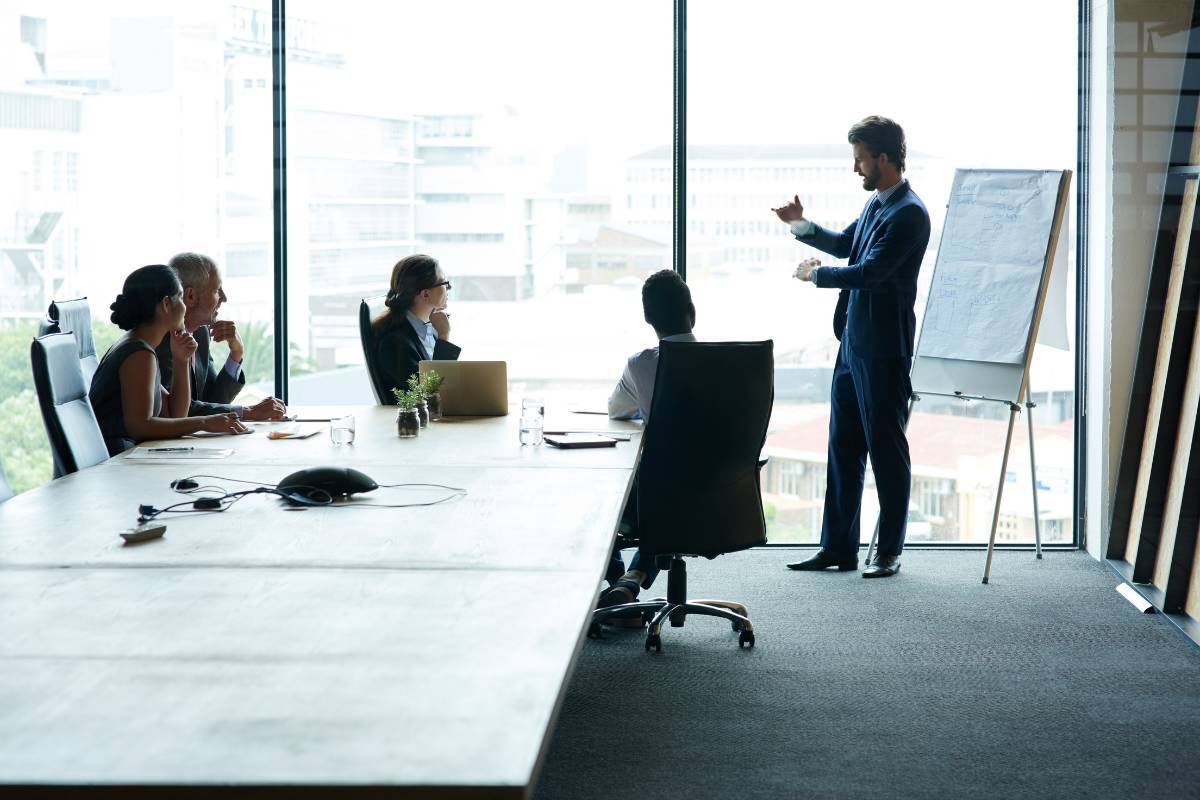 Team members engage in a discussion led by a presenter, aiming to structure impactful tiers for a loyalty program.