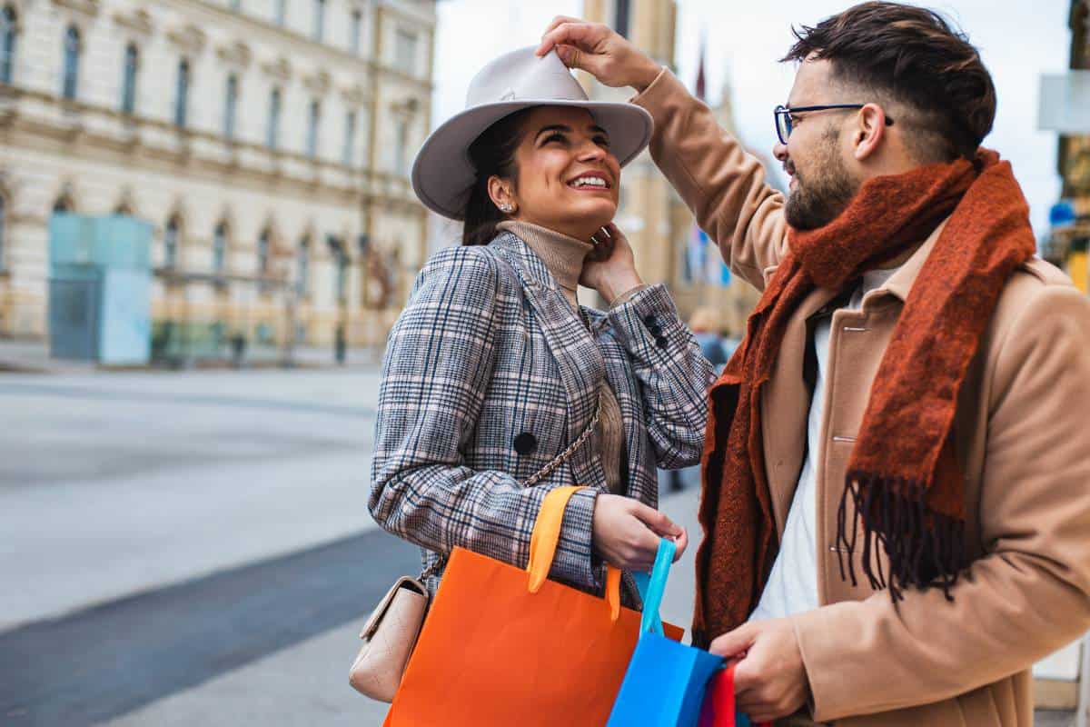 A traveling couple shares a joyful experience exploring shops